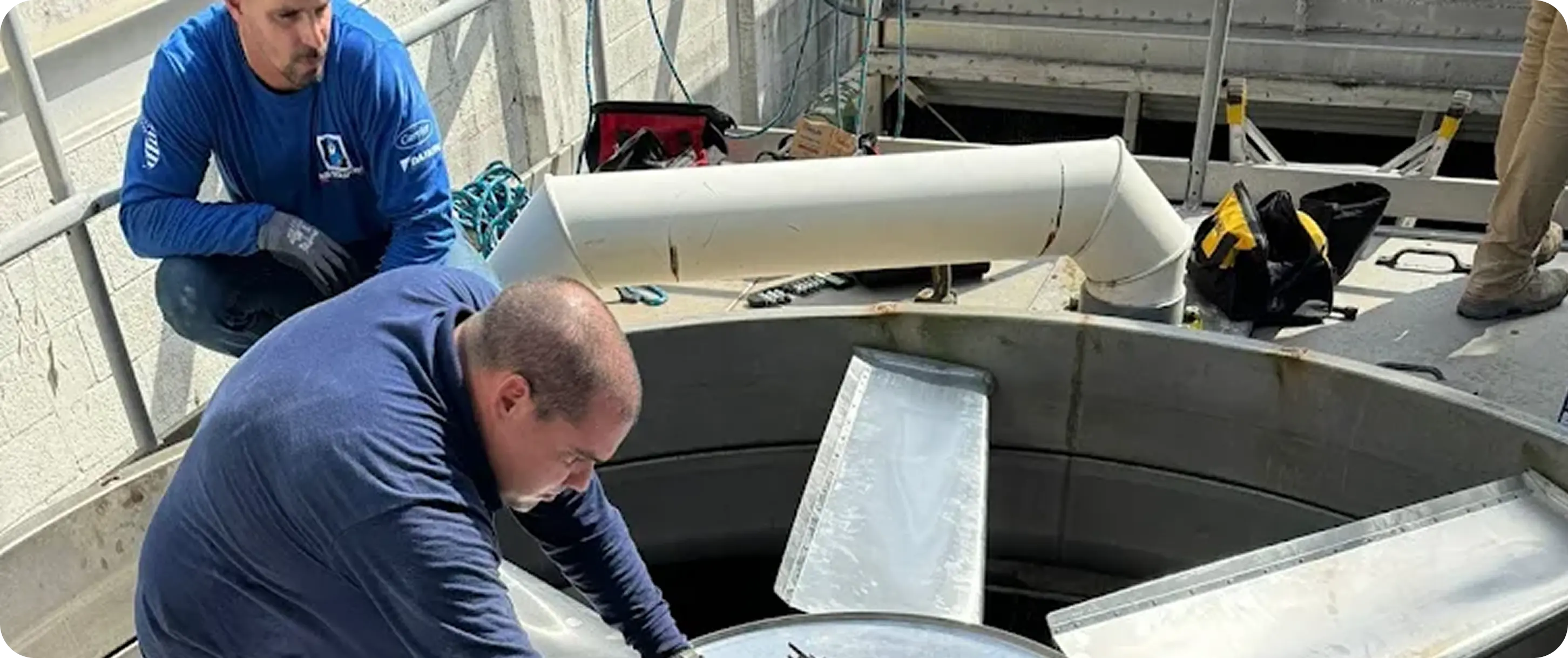 Technician performing HVAC repair work
