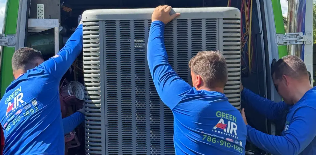 Technicians positioning an outdoor AC condenser unit
